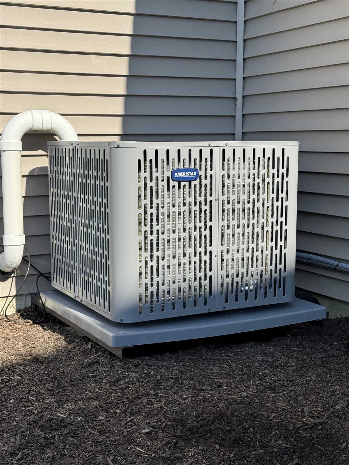 Ameristar outdoor air conditioning condenser installed beside a home